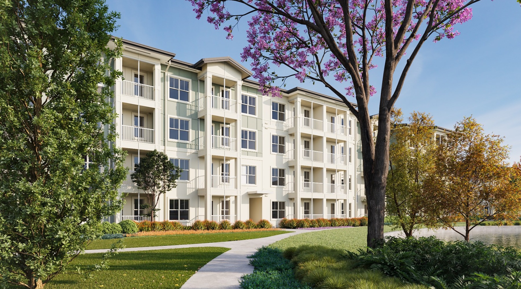 a building near a pond and lush landscaping