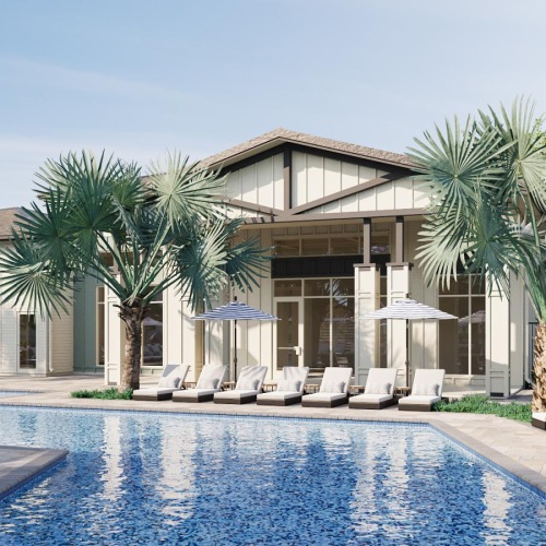 a swimming pool with chairs and umbrellas next to a large building at Preserve at West Carroll in Kissimmee, Florida